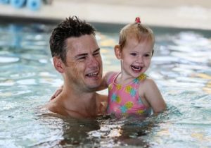 Father and child swimming