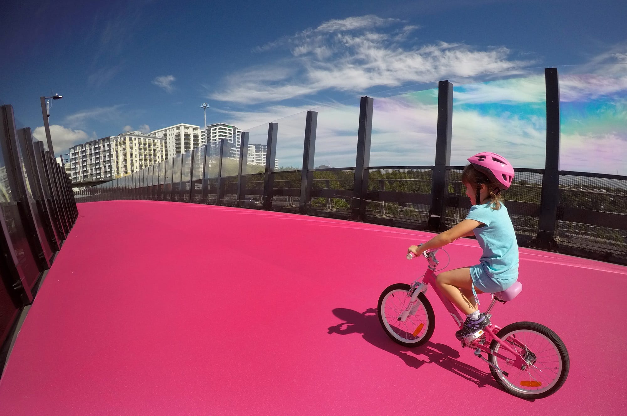 Young girl riding a bike on the pink cycleway in Auckland, NZ