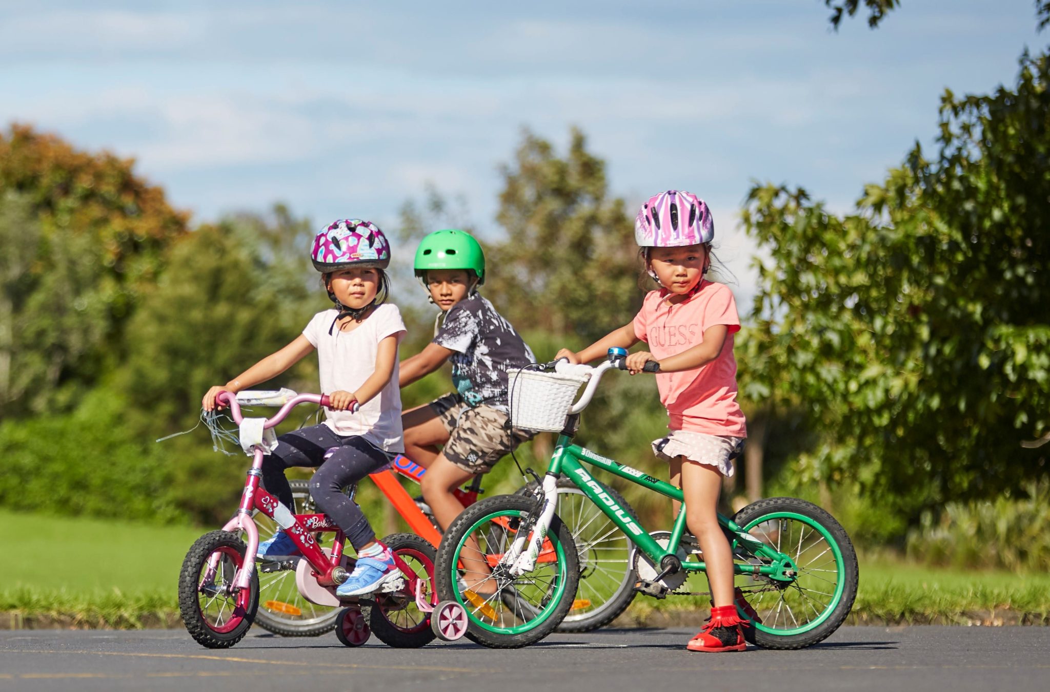 Children riding Bicycles. Friends teens and Kids Ride Bikes. The children ride bikes