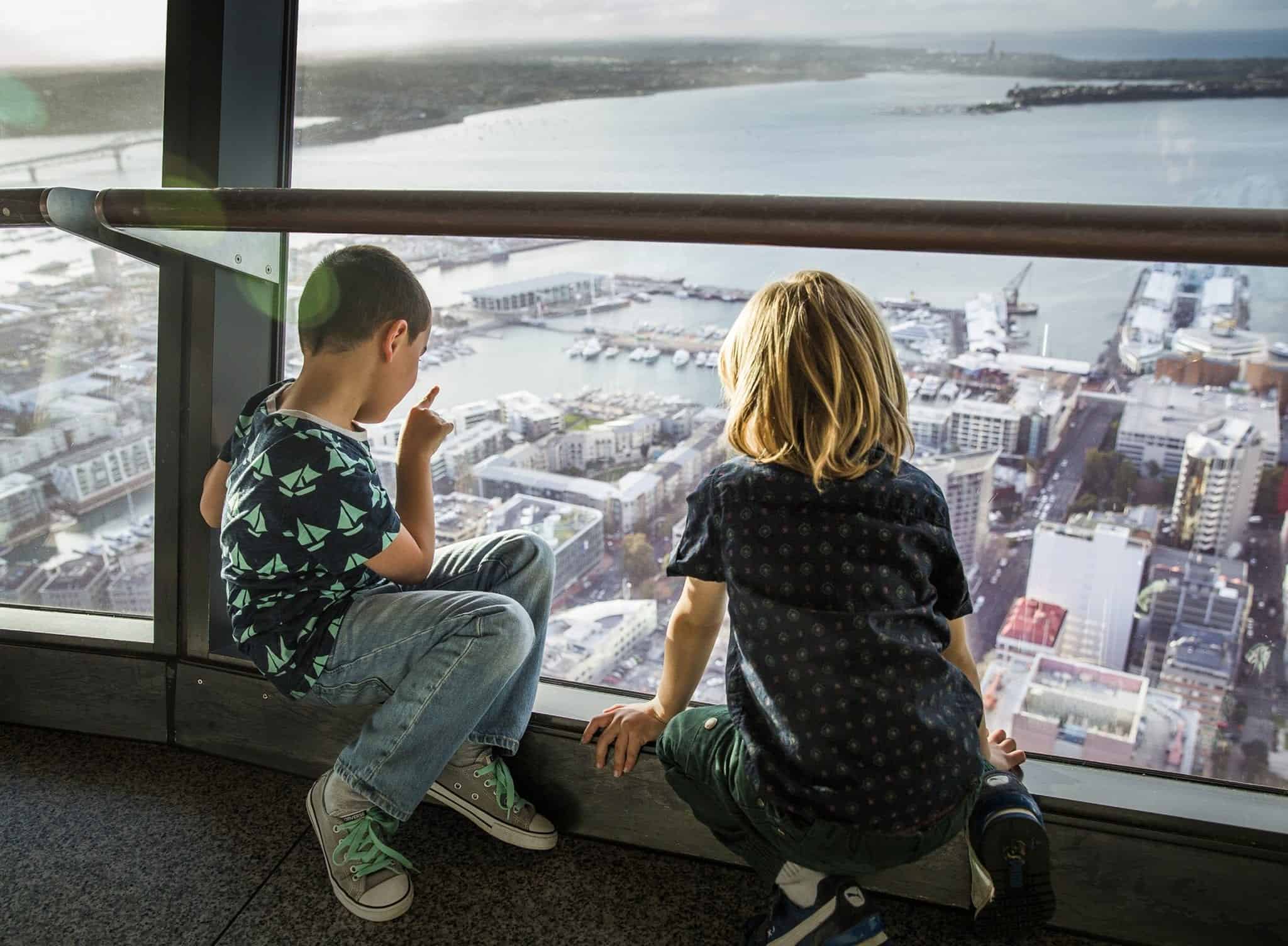 Boys up the Sky Tower overlooking Auckland City
