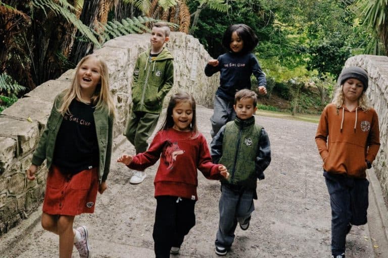 Children walking outdoors wearing Band of Boys and The Girls Club clothing
