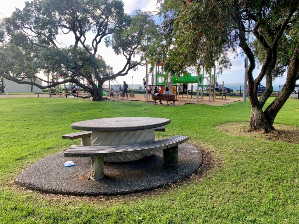 Picnic tables at Eastern Beach Fully fenced playground, East Auckland, New Zealand | Photo: Auckland for Kids