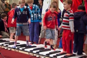 Children playing on organ keys