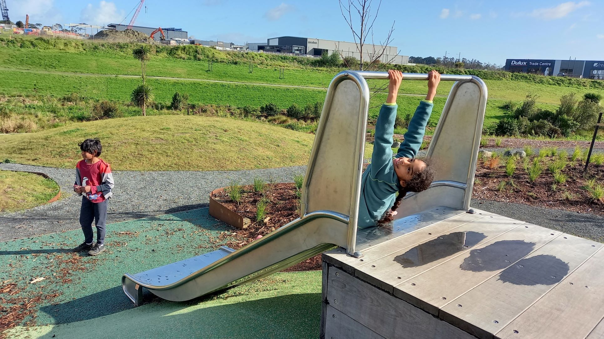 Playing on the slide at Kopupaka Playground