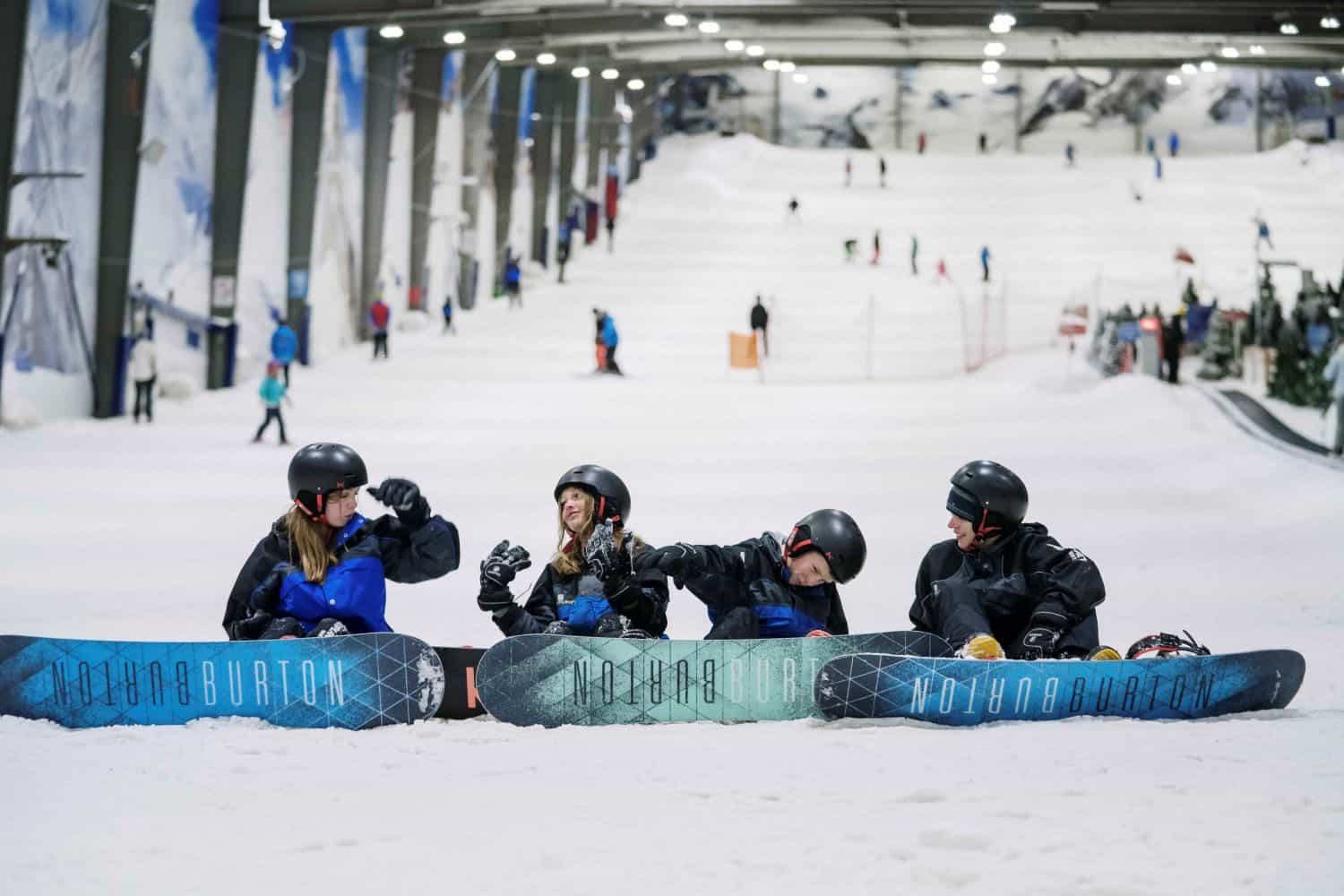 Kids snowboarding at Snowplanet indoor snow park in Auckland, New Zealand