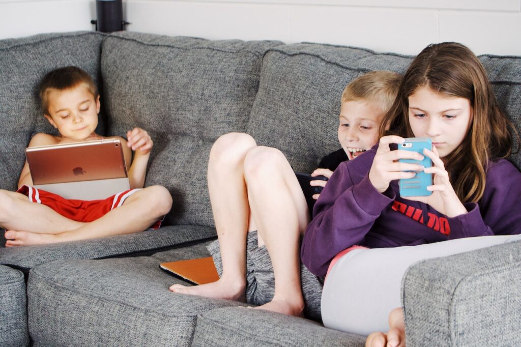 children relaxing with their technology