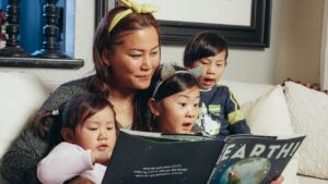 Mother and children reading together