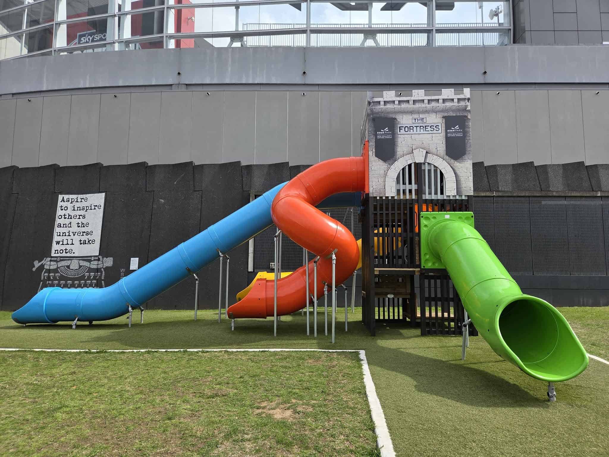 Colourful tunnel slides and a castle-themed tower at Eden Park's playground on Reimers Avenue.