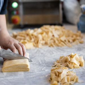Fresh pasta being hand-cut on a floured bench at Baduzzi restaurant in Auckland