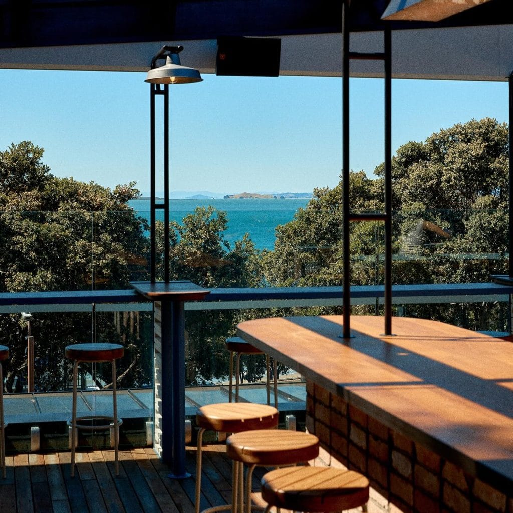 Seating area at Takapuna Surf Club with ocean views over the Hauraki Gulf
