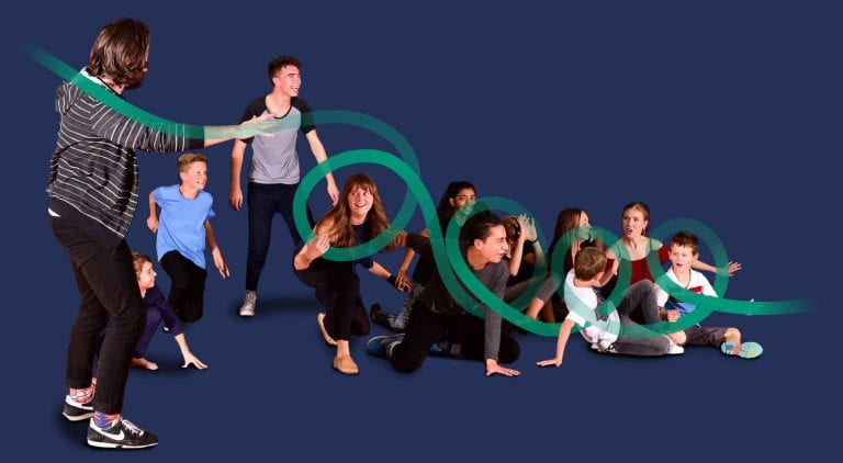 Young children and teens participating in a drama activity with an instructor at National Youth Theatre