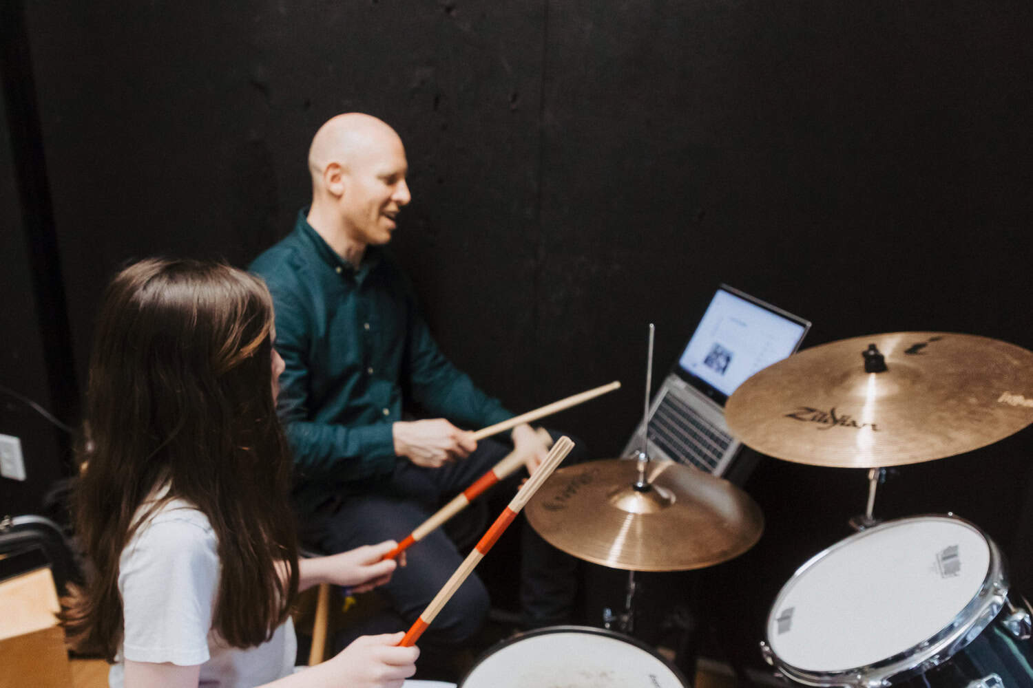 Child learning to play the drums at Modern Music School
