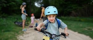 Child learning to ride a bike on a family friendly trail