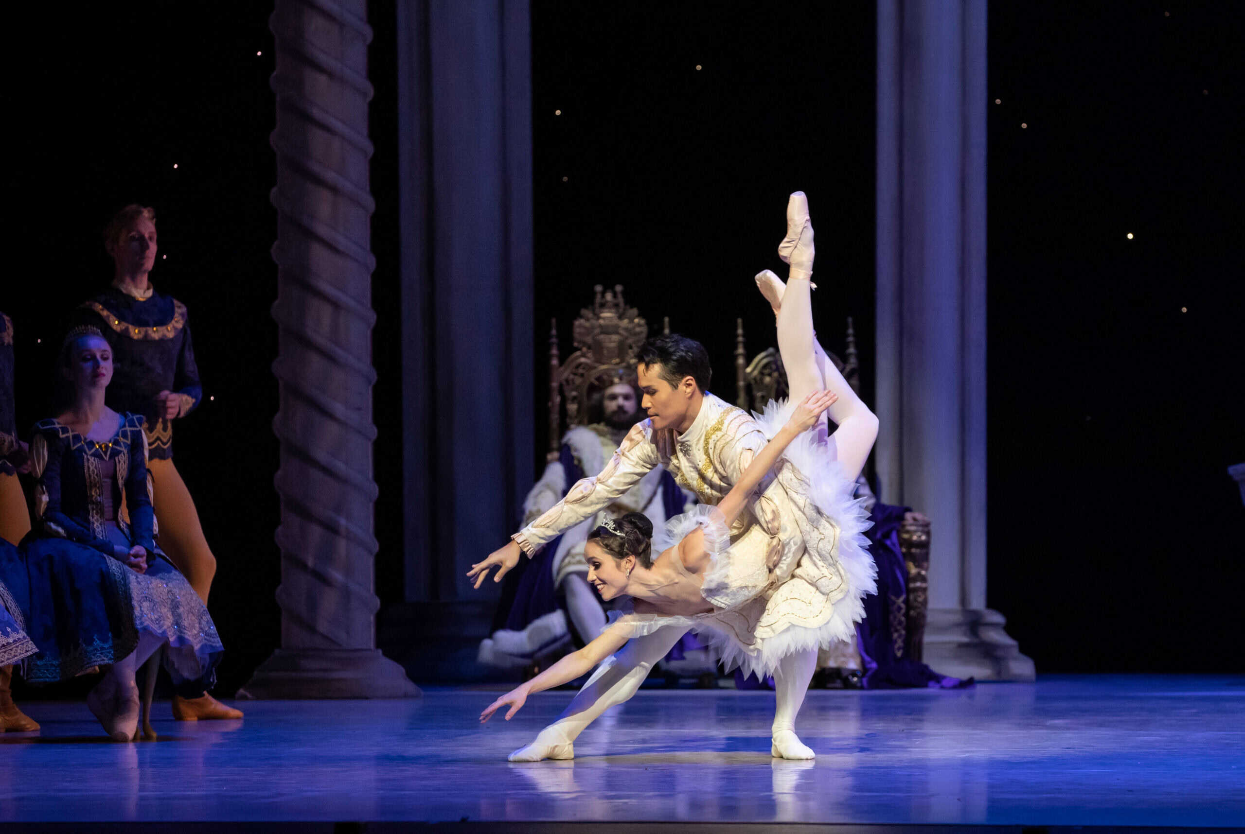 A ballet dancer in The Sleeping Beauty performing on stage with soft blue lighting.
