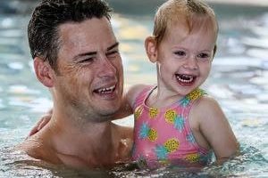 Father and child swimming